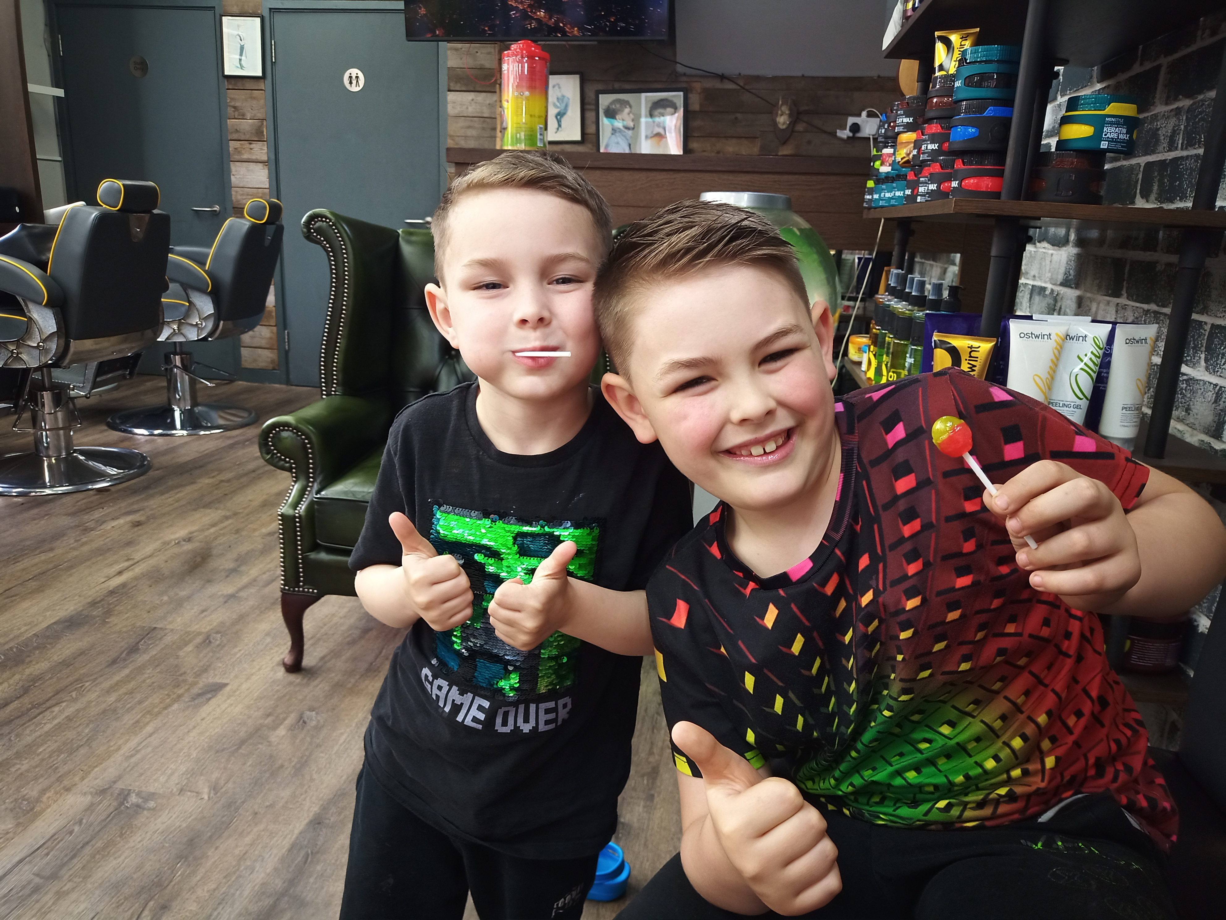 George and Alfie smiling and giving thumbs up